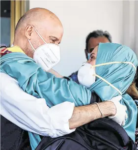  ?? PHOTO: HANDOUT VIA REUTERS ?? Welcome home: Silivia Romano is hugged by her father Enzo after she got off the aircraft at Rome’s Ciampino Airport.