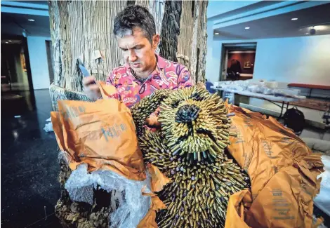  ??  ?? Artist Federico Uribe unwraps a baboon made out of bullet casings. It will be featured with his art of a tree made of old khaki pants and green socks that will be displayed in the rotunda of the Memphis Brooks Museum of Art. MARK WEBER/THE COMMERCIAL APPEAL