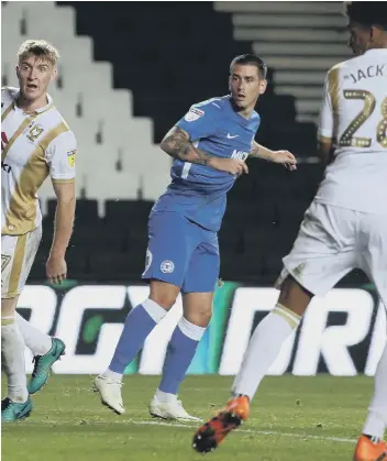  ??  ?? Jamie Walker (blue) during his Posh debut at MK Dons.