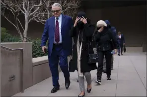  ?? (AP/Eric Thayer) ?? David Chesnoff, defense attorney for Alexander Smirnov (left), walks out of federal court with a group of unidentifi­ed people in Los Angeles on Monday.