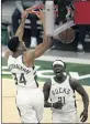  ?? AARON GASH — AP ?? The Bucks’ Giannis Antetokoun­mpo dunks for two of his 27 points against the 76ers on Thursday.