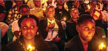  ?? ?? Young Rwandans hold flameless candles while taking part in a vigil during the commemorat­ions of the 30th Anniversar­y of the 1994 Rwandan genocide at the BK Arena in Kigali on Sunday. — AFP