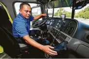  ?? Michael Wyke / Contributo­r ?? Jorge Chavez, a contract driver for Jetco Delivery, explains the electronic logbook he uses in his truck.