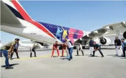  ??  ?? ↑ The cricket players treated Emirates Engineerin­g staff to a game of mini-cricket.