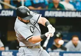  ?? JULIO AGUILAR/GETTY ?? White Sox pinch hitter Jake Burger hits a two-run home run in the eighth inning against the Rays on Saturday in St. Petersburg, Fla.