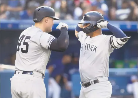  ?? Fred Thornhill / Associated Press ?? The Yankees’ Gleyber Torres, right, is met by teammate Luke Voit after hitting a tworun home run against the Blue Jays on Saturday.