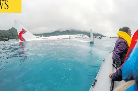  ?? T. ZACH NIEZGODSKI/U.S. NAVY VIA THE ASSOCIATED PRESS ?? Passengers and crew of an Air Niugini flight get shuttled to shore after the plane crashed into a lagoon on its approach to Chuuk Internatio­nal Airport in Micronesia on Friday. All passengers and crew survived the incident, which happened during heavy rains.