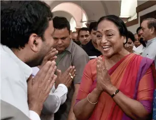  ?? PTI ?? Meira Kumar exchanging greetings with political leaders and workers after filing her nomination papers at Parliament House in New Delhi on Wednesday. —