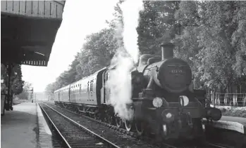  ?? Keith Widdowson/ANISTR.COM ?? Known locally as the ‘6-5 special’, Guildford shed’s No 41299 has arrived at Baynards with the 18.05 Guildford to Horsham service on 19 May 1965. The author detrained here and changed platforms to catch the 18.15 ex-Horsham but took this view as he passed over the level crossing in readiness to join that train. The idea of rushing between platforms in the window when two trains are booked to pass is classic for those seeking haulage, and here it was not too stressful thanks to the process of tablet exchange – the section of line from Christ’s Hospital through to Peasmarsh Junction was single-track with passing loops. The signalman had to communicat­e with the neighbouri­ng boxes, confirming that the trains were out of section, gain permission to send each train onwards,. Then of course he would amble back out to each locomotive crew to hand-over the correct staff for them to proceed.