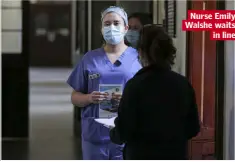  ??  ?? Nurse Emily Walshe waits in line