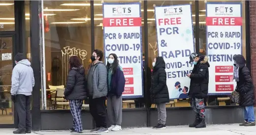  ?? NAM Y. HUH/AP ?? People line up to take a COVID-19 test at a free testing site in Chicago at the end of December. Infection rates are surging across the city and state, threatenin­g not only physical but mental health.
