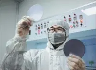  ?? SHENG WENPENG / FOR CHINA DAILY ?? A worker inspects auto chips at Anxin Electronic Technology Co in Chizhou, Anhui province. Currently, China still relies heavily on import of crucial auto chips.