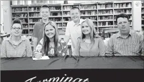  ?? LYNN KUTTER ENTERPRISE-LEADER ?? Jessika Calhoon, a senior at Farmington High School, signed a letter of intent last week for the livestock judging team at Eastern Oklahoma State College in Wilburton, Okla. She is pictured with Eastern coach Jade Jenkins, left, her parents John and...