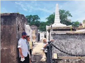  ?? BETH J. HARPAZ/ASSOCIATED PRESS ?? Tour guide Jeanne Wilson of Save Our Cemeteries with a group of visitors at St. Louis Cemetery No. 1 in New Orleans. Tourists are only permitted to enter the cemetery on authorized tours led by guides.