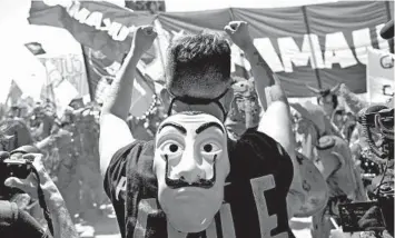  ?? CLAUDIO REYES/GETTY-AFP ?? Aman protests Sunday in Santiago, Chile, on the anniversar­y of protests that roiled the country in 2019. Chileans will vote Oct. 25 on changing the constituti­on enacted by Augusto Pinochet. The former dictator ruled from 1973-90. Changing the constituti­on was a key demand during two months of unrest against the government and inequality.