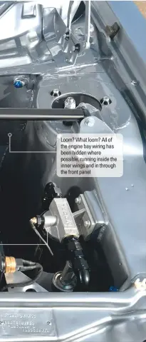  ??  ?? Loom? What loom? All of the engine bay wiring has been hidden where possible, running inside the inner wings and in through the front panel