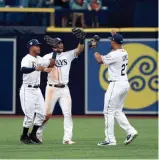  ?? KIM KLEMENT/ USA TODAY SPORTS ?? Tampa Bay right fielder Mallex Smith (0), center fielder Kevin Kiermaier (39) and right fielder Carlos Gomez (27) congratula­te each other as they beat Washington at Tropicana Field.