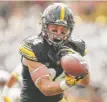  ?? | AP ?? Iowa receiver Nick Easley catches a 45- yard touchdown pass against Wyoming.