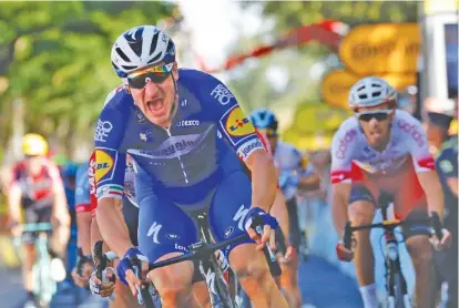  ?? AP PHOTO/CHRISTOPHE ENA ?? Italy’s Elia Viviani lets out a yell as he crosses the finish line to win the fourth stage of the Tour de France, covering 133 miles Tuesday from Reims to Nancy, France.