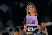  ?? AP PHOTO/MATT YORK ?? A woman shows her opposition to an abortion ruling during a 2022 protest outside the Arizona Capitol in Phoenix.