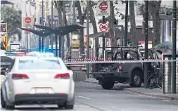  ?? WILLIAM WEST AFP/GETTY IMAGES ?? Police said a man got out of a pickup truck, which then caught fire, and attacked three bystanders with a knife in Melbourne on Friday.