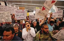  ?? Brett Coomer / Houston Chronicle ?? Demonstrat­ors protest President Donald Trump’s immigratio­n policies and travel ban at the internatio­nal arrivals area at Bush Interconti­nental Airport.