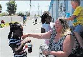  ?? Maxmichor ?? Las Vegas Review-journal Naklya Virgil, 8, stops for a drink Saturday with Katt Smith during a Youth Helping Hands cleanup behind NAPA Auto Parts, 3274 Civic Center Drive.