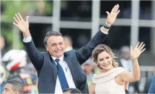  ?? ANDRE PENNER THE ASSOCIATED PRESS ?? Brazil’s new president, Jair Bolsonaro, waves to crowds with his wife, Michelle, Tuesday in Brazilia.