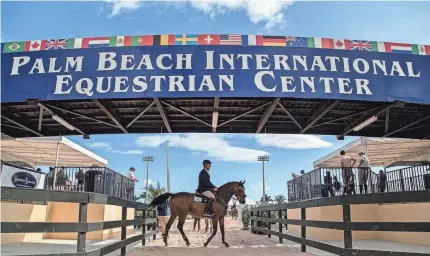  ?? THE PALM BEACH POST ?? Christoph Schroeder riding Diamant De Revel waits to compete in the Holiday Finale at the Palm Beach Internatio­nal Equestrian Center in Wellington. An expansion proposal would double the size of the facility.