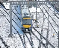  ?? Pictures: ?? Clockwise from left: a street in Glasgow under a blanket of snow; police push a car on the M80 Haggs in Glasgow and a ScotRail train leaves Edinburgh’s Waverley Station.