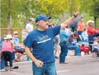  ?? EDDIE MOORE/JOURNAL ?? School board member Rudy Garcia, a candidate for Santa Fe County Commission­er, greets people near the corner of West Alameda Street and Sandoval Street during the Fiesta de Santa Fe’s Historical Hysterical Parade on Sept. 9.