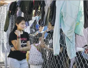  ?? Gregory Bull Associated Press ?? UNDER THE restored “Remain in Mexico” policy, the U.S. will be returning migrants at seven locations to Mexico to await hearings. Above, migrants at a makeshift camp near the crossing in Tijuana last month.