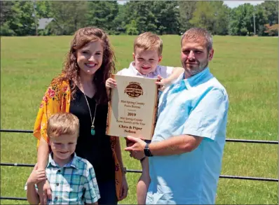  ?? PHOTOS BY SAM PIERCE/TRILAKES EDITION ?? The Nelson family of Malvern is the 2019 Hot Spring County Farm Family of the Year. From left are Grant, 6; Piper; Noah, 4; and Chris. The Nelsons have 89 acres altogether, including 40 at their home in Malvern.