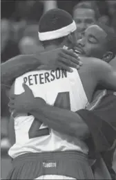  ?? AARON HARRIS, THE CANADIAN PRESS ?? Detroit Pistons’ Mateen Cleaves hugs Toronto Raptors’ Morris Peterson following the season opener in Toronto on Oct. 31, 2000.