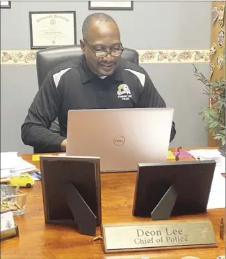  ?? Brodie Johnson • Times-Herald ?? Forrest City Police Chief Deon Lee reviews report and call logs from the year. Lee says he’s proud of department’s hard work in the face of challenges this year.