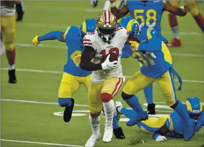  ?? KELVIN KUO — THE ASSOCIATED PRESS ?? San Francisco 49ers wide receiver Deebo Samuel (19) carries after a catch during the second half against the Los Angeles Rams last Sunday in Inglewood.