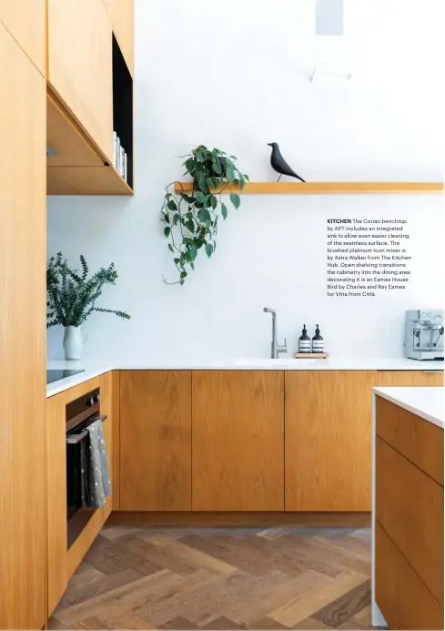  ??  ?? KITCHEN The Corian benchtop by APT includes an integrated sink to allow even easier cleaning of the seamless surface. The brushed platinum Icon mixer is by Astra Walker from The Kitchen Hub. Open shelving transition­s the cabinetry into the dining area; decorating it is an Eames House Bird by Charles and Ray Eames for Vitra from Città.