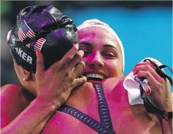  ?? ADAM PRETTY/GETTY IMAGES ?? Kylie Masse, right, is congratula­ted by silver medallist Kathleen Baker of the United States after winning 100-metre backstroke gold on Tuesday.