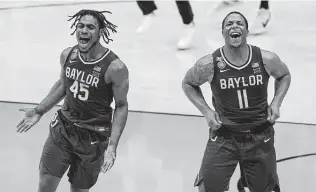  ?? Darron Cummings / Associated Press ?? Baylor’s Davion Mitchell (45) and Mark Vital soak up the national championsh­ip feeling after a stellar performanc­e by the Bears in a 86-70 victory against Gonzaga on Monday in Indianapol­is.