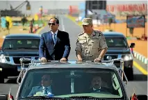  ?? PHOTO: REUTERS ?? Egyptian President Abdel Fattah al-Sisi, left, rides a vehicle with Egypt’s Minister of Defence Sedki Sobhi during a presentati­on of combat efficiency and equipment of the armed forces in Suez.