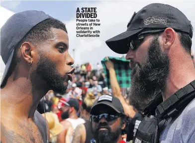  ??  ?? A STATE DIVIDED People take to streets of New Orleans in solidarity with Charlottes­vile