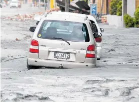  ?? Photo / NZME ?? Cars stuck in mud from liquefacti­on in Christchur­ch after the 2011 quake.