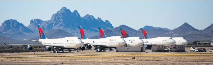  ?? PHOTOS BY THE NEW YORK TIMES ?? Delta Air Lines Boeing 747s are cleaned and prepped for storage at Pinal Airpark, which is sometimes called a graveyard or boneyard for planes, in Marana, Arizona.