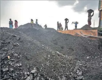  ?? GETTY IMAGES ?? ▪ Labourers load a truck with coal at depot in Jaintia Hills, Meghalaya. In the state’s political field, all actors are privately conscious of the need to protect the environmen­t, but they publicly want to be seen as favouring the economy.