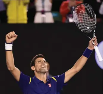  ?? WILLIAM WEST/AFP/GETTY IMAGES ?? Novak Djokovic raises his arms in triumph after defeating Andy Murray to win his sixth Australian Open title.