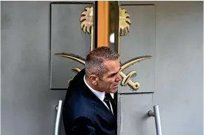  ?? AP ?? A security guard looks out of the entrance of Saudi Arabia’s consulate in Istanbul.