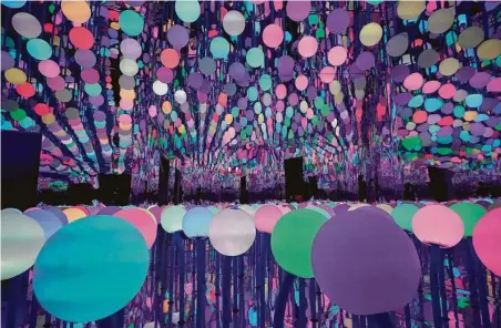  ?? Melissa Phillip / Staff photograph­er ?? “Alien Grass” is an infinity room of 200 LED orbs that change color and patterns.