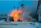  ?? ?? Fire fighters extinguish the blaze at Russia’s second-largest natural gas producer, Novatek in Ust-Luga, 21 January, following two explosions. Photograph: AP