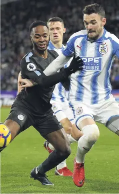  ?? AP ?? Manchester City’s Raheem Sterling (left) and Huddersfie­ld’s Scott Malone battle for the ball during their English Premier League match at John Smith’s Stadium in Huddersfie­ld, England, yesterday.