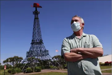  ?? TONY GUTIERREZ — THE ASSOCIATED PRESS ?? Mayor Steve Clifford poses for a photo in front of the iconic, small version of the Eiffel Tower in Paris, Texas.